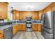 Well-lit kitchen with stainless steel appliances, granite countertops, and light wood cabinetry at 1013 E Academy St, Cherryville, NC 28021