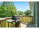 Wooden deck with grill and green views, perfect for outdoor cooking and entertaining at 1013 Old Charlotte Rd, Statesville, NC 28677