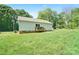 Green backyard with grass, trees, and sunlight creating a perfect outdoor area at 1013 Old Charlotte Rd, Statesville, NC 28677