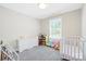 A tidy Bedroom with a crib, dresser, and window with natural light creating a cozy space at 1013 Old Charlotte Rd, Statesville, NC 28677