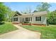 Well-maintained home with a sidewalk leading to the front door and green lawn at 1013 Old Charlotte Rd, Statesville, NC 28677