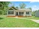 Charming one-story home with black shutters and inviting front porch on a sunny day at 1013 Old Charlotte Rd, Statesville, NC 28677