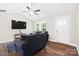Cozy living room featuring hardwood floors, a ceiling fan, and a large window at 1013 Old Charlotte Rd, Statesville, NC 28677