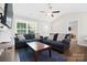 Inviting living room area featuring a ceiling fan, hardwood floors, and comfortable seating at 1013 Old Charlotte Rd, Statesville, NC 28677