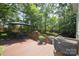 Wooden deck with seating, mature trees, and lush landscaping creates a relaxing outdoor space at 1023 Evian Ln, Matthews, NC 28105
