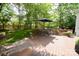 Wooden deck features dining area, lush landscaping, and peaceful outdoor space for entertaining at 1023 Evian Ln, Matthews, NC 28105