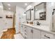 This bathroom features a double vanity with marble countertops, wood floors, and walk-in shower at 1023 Evian Ln, Matthews, NC 28105