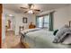 This bedroom has a ceiling fan, a window with green curtains, and a wooden dresser at 1023 Evian Ln, Matthews, NC 28105