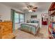 This bedroom has a ceiling fan, a window with green curtains, and a wooden dresser at 1023 Evian Ln, Matthews, NC 28105