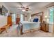This primary bedroom has a large bed with a wooden frame, two windows, and two dressers at 1023 Evian Ln, Matthews, NC 28105