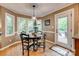Bright dining area featuring hardwood floors, bay windows, and access to the outdoor deck at 1023 Evian Ln, Matthews, NC 28105