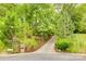 View of the property's long private driveway leading to the home, lined with mature landscaping and trees at 1023 Evian Ln, Matthews, NC 28105