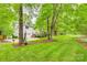 Two-story home with a well-maintained lawn, driveway, and wooden deck at 1023 Evian Ln, Matthews, NC 28105