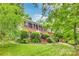 Charming brick home with lush landscaping, inviting stairs, and classic architectural details at 1023 Evian Ln, Matthews, NC 28105