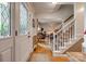 Bright foyer with hardwood floors, leaded glass door, and staircase leading to upper level at 1023 Evian Ln, Matthews, NC 28105