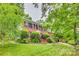 Traditional brick home with manicured lawn, mature landscaping, and black shutters for classic curb appeal at 1023 Evian Ln, Matthews, NC 28105