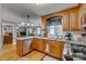 Charming kitchen boasts stainless appliances, granite countertops, and an open view to the living room at 1023 Evian Ln, Matthews, NC 28105