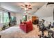 Spacious living room featuring plush carpet, ceiling fans, and a comfortable red sofa at 1023 Evian Ln, Matthews, NC 28105