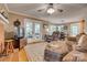 Open-concept living room with hardwood floors, fireplace, and access to outdoor living spaces at 1023 Evian Ln, Matthews, NC 28105