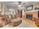 Spacious living room featuring a brick fireplace, hardwood floors, and comfortable furnishings at 1023 Evian Ln, Matthews, NC 28105
