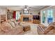 Cozy living room with a brick fireplace, plush seating, and natural light at 1023 Evian Ln, Matthews, NC 28105