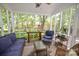 Screened porch with wicker furniture offers a cozy and relaxing outdoor living space at 1023 Evian Ln, Matthews, NC 28105