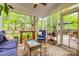 Bright sunroom with wicker furniture, plants, and views of the backyard at 1023 Evian Ln, Matthews, NC 28105