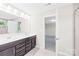 Bathroom featuring double sinks, a large mirror, and access to a separate shower and tub area at 106 Kirsche Ct, Mooresville, NC 28115