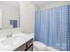 Neat bathroom with a single vanity, white toilet, and a blue patterned shower curtain at 106 Kirsche Ct, Mooresville, NC 28115