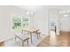 Bright dining area features a chandelier, light wood flooring, and natural light from a large window at 106 Kirsche Ct, Mooresville, NC 28115