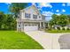 Attractive two-story home with stone accents, a two-car garage, and a well-manicured lawn at 106 Kirsche Ct, Mooresville, NC 28115
