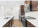 Modern kitchen with an island, stainless steel appliances and dark wood cabinets at 106 Kirsche Ct, Mooresville, NC 28115