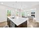 Open concept kitchen with large island and pendant lighting, flowing into living area at 106 Kirsche Ct, Mooresville, NC 28115