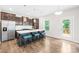 Contemporary kitchen with a large island, dark cabinets, stainless steel appliances, and wood floors at 106 Kirsche Ct, Mooresville, NC 28115