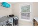 Well-equipped laundry room with modern washer and dryer set and window with natural light at 106 Kirsche Ct, Mooresville, NC 28115