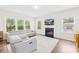 Open living room offers a fireplace, large windows, recessed lighting, and comfortable seating at 106 Kirsche Ct, Mooresville, NC 28115