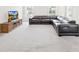 Bright living room with neutral carpet, large windows, and a modern sectional sofa at 106 Kirsche Ct, Mooresville, NC 28115