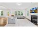 Bright living room with a fireplace, windows, recessed lights, and cozy seating area at 106 Kirsche Ct, Mooresville, NC 28115