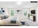 Staged primary bedroom with soothing colors, large windows, and stylish decor for a relaxing retreat at 106 Kirsche Ct, Mooresville, NC 28115