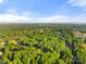 Ariel view of a lush wooded landscape with a golf course and small pond at 108 Augusta Dr, Statesville, NC 28625