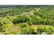 Aerial view highlighting a golf course with trees, fairways and a clubhouse at 108 Augusta Dr, Statesville, NC 28625