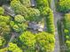 An aerial view of a home surrounded by mature trees with a long driveway at 108 Augusta Dr, Statesville, NC 28625