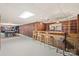 Basement bar with wooden bar, chairs, and shelves, with pool table in background, great for gatherings at 108 Augusta Dr, Statesville, NC 28625