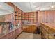 Basement bar area with wood accents, ample shelving, and sink at 108 Augusta Dr, Statesville, NC 28625