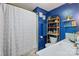 Well-lit bathroom with a shower, toilet, sink, and wooden storage shelves for toiletries at 108 Augusta Dr, Statesville, NC 28625