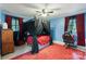 Blue bedroom featuring a red rug and canopy bed, illuminated by a modern ceiling fan at 108 Augusta Dr, Statesville, NC 28625