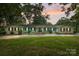 Charming single-story home with light blue siding, black shutters, mature trees, and a well-manicured front lawn at 108 Augusta Dr, Statesville, NC 28625