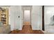 Hallway with hardwood floors leading to various rooms, offering a view of the home's layout at 108 Augusta Dr, Statesville, NC 28625