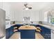 Updated kitchen featuring a blue island, white subway tile backsplash, and stainless steel appliances at 108 Augusta Dr, Statesville, NC 28625