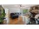 Comfortable living room featuring wood floors, a ceiling fan, a gray couch and a set of french doors at 108 Augusta Dr, Statesville, NC 28625